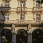 a car parked in front of a tall building