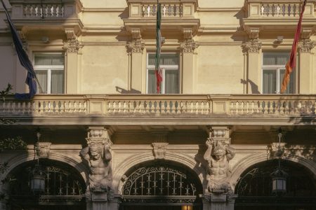 a car parked in front of a tall building