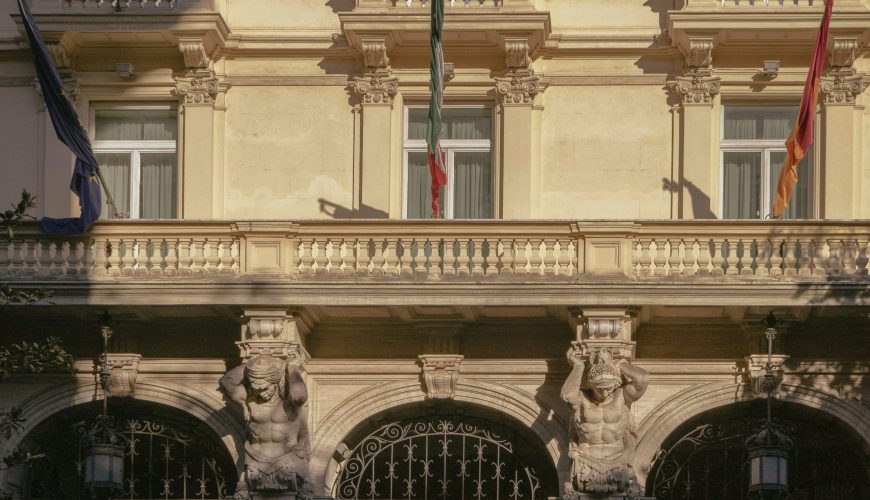 a car parked in front of a tall building